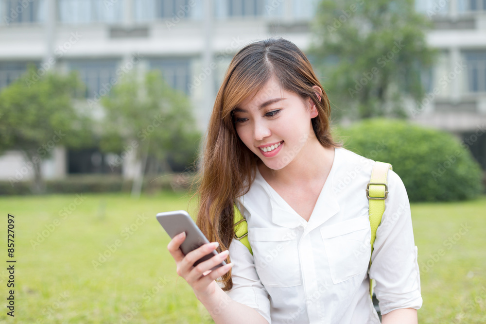 Asian beautiful female studen using mobile phone in campus Asian beautiful female studen using mobile phone in campus