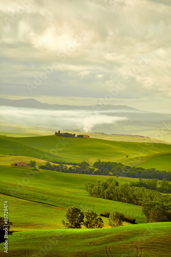 Tuscany  rural sunset landscape. Countryside farm  cypresses tre