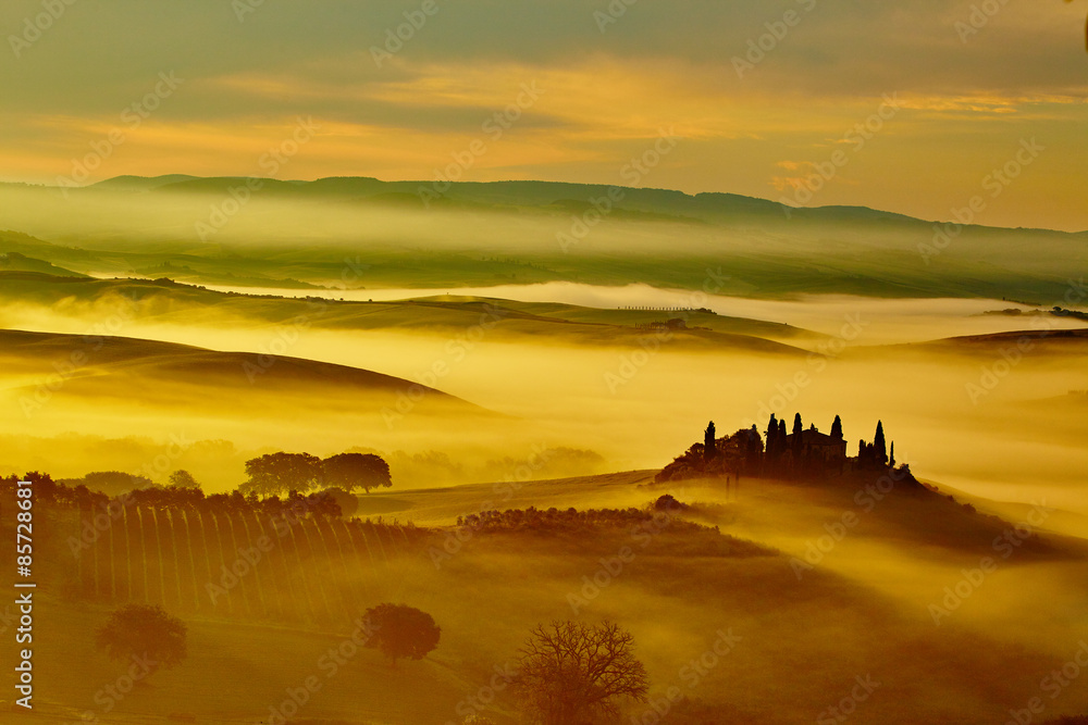 Scenic Tuscany landscape with rolling hills and valleys in golde