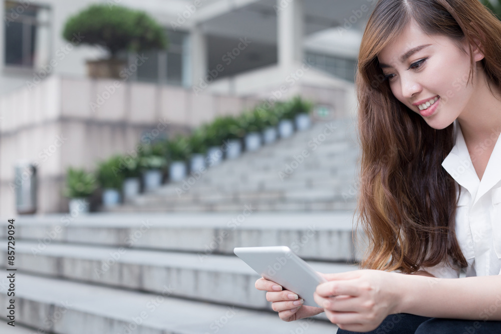 Asian female student using tablet in campus Asian female student using tablet in campus