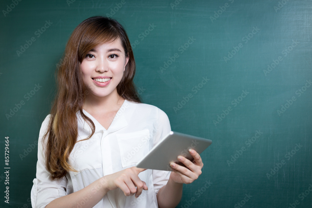 asian beautiful woman holding tablet in front of blackboard asian beautiful woman holding tablet in front of blackboard