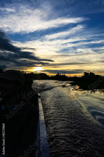 Sunset. Boat Crossing the Amazon. photo