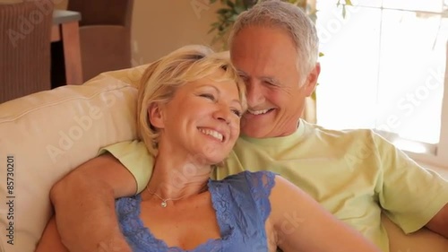 dolly shot of senior couple relaxing on sofa 