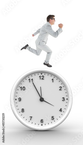 Composite image of geeky happy businessman running mid air