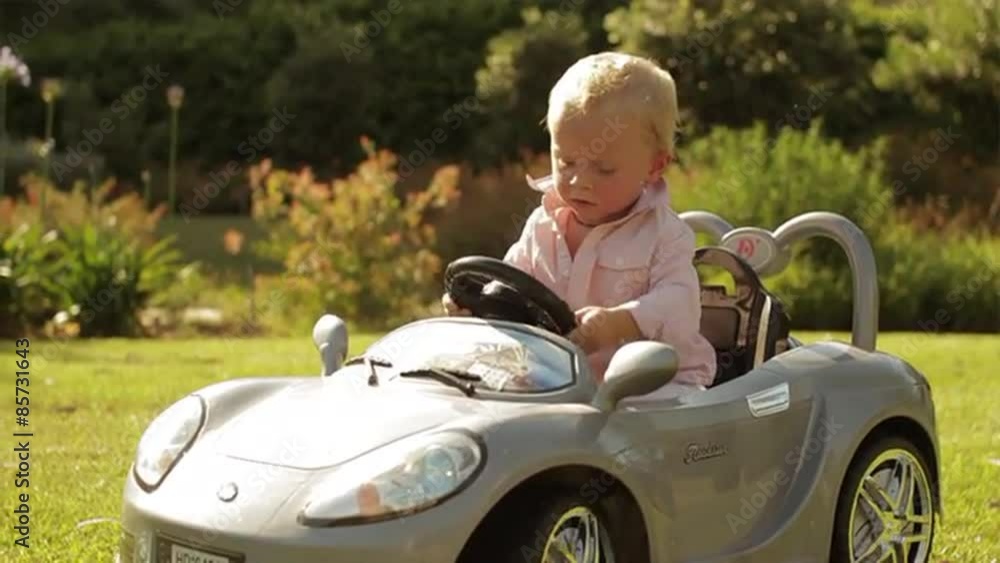 Slow motion of toddler playing in toy car. Slow motion of toddler playing in toy car.