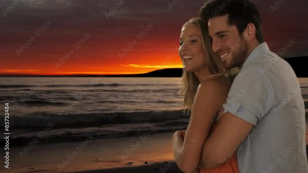 young couple hugging on beach in sunset young couple hugging on beach in sunset