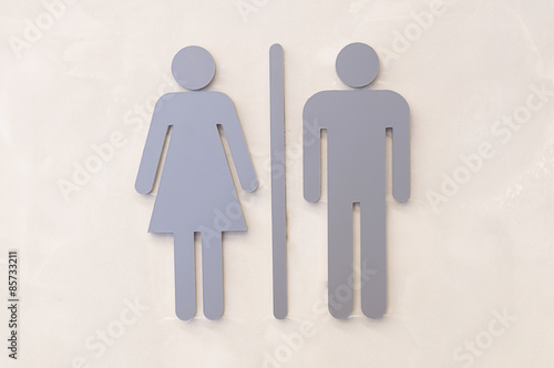 Grey woman and man sign one the wall