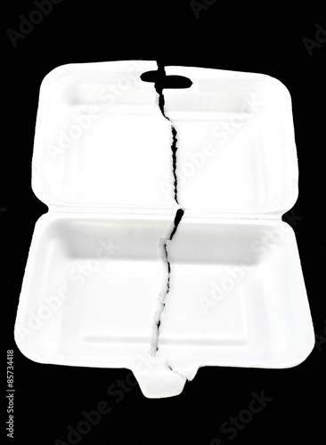 teared white foam box on black background