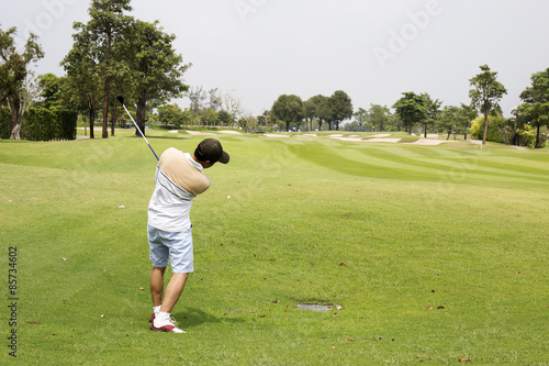 Man playing golf alone