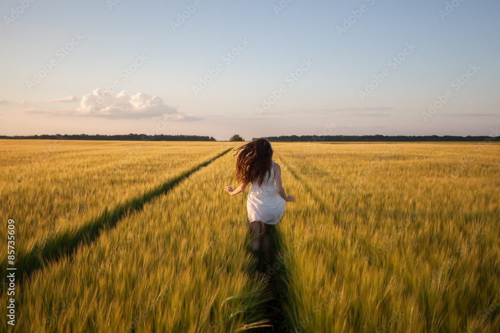 woman run  in yellow wheat field