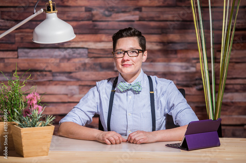 Dapper Woman in Hipster Office with Tablet photo