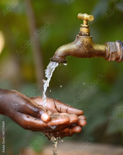 Social Issues: Water Scarsity Problem: Drinking Symbol for African Children photo