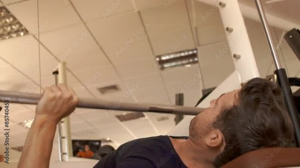 Man lifting weights at gym. Man lifting weights at gym.