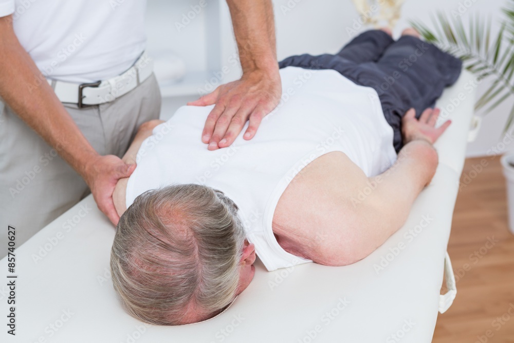 Fototapeta premium Physiotherapist doing shoulder massage to his patient