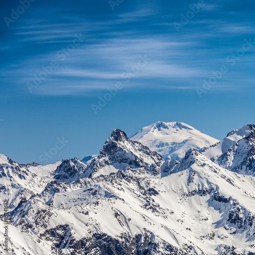 Snowy peaks against the blue sky © Denis Ponkratov
