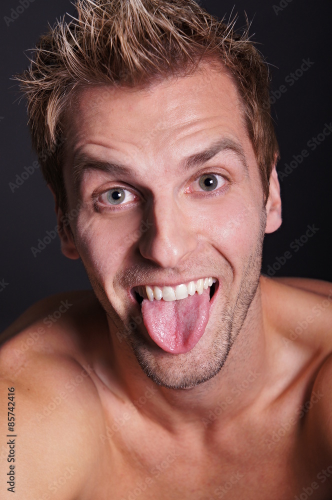 Young crazy man sticks out his tongue Young crazy man sticks out his tongue