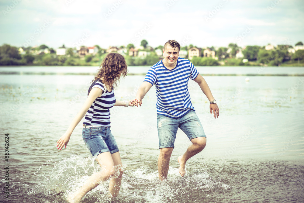 Fototapeta premium Pretty couple outdoor, running on the lake