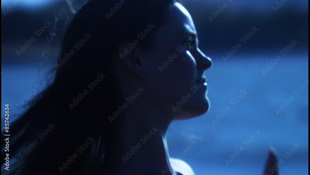 Woman walking by water in a dream, hair blowing Woman walking by water in a dream, hair blowing
