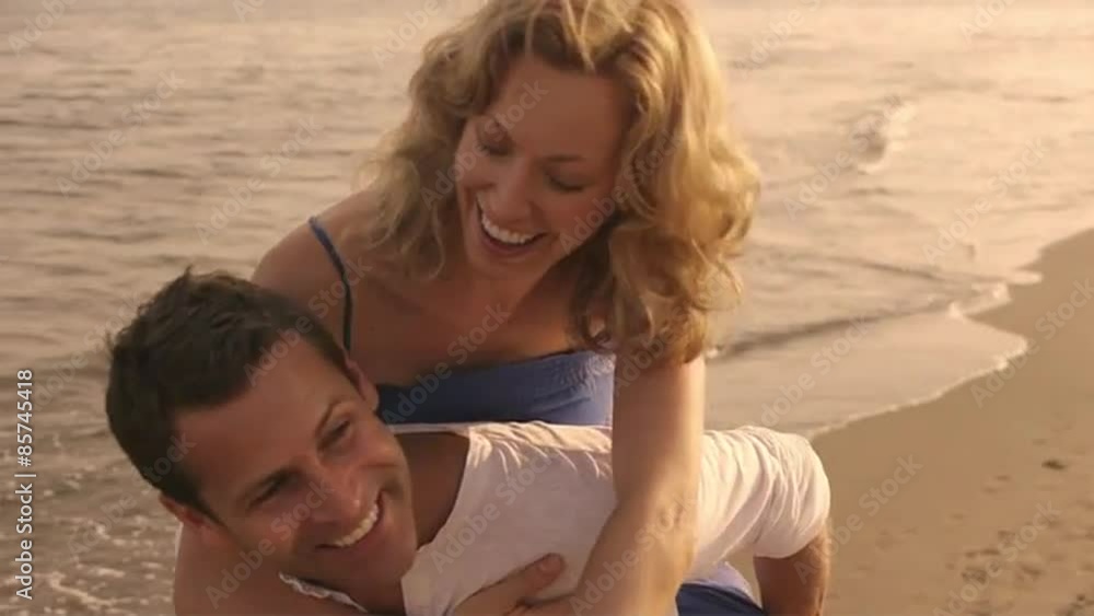 Slow motion shot of playing couple on beach. Slow motion shot of playing couple on beach.