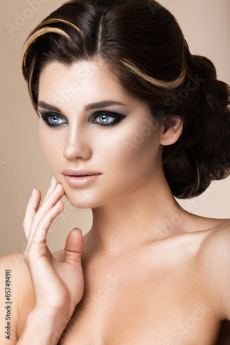 Beautiful brunette girl with evening make-up and perfect skin