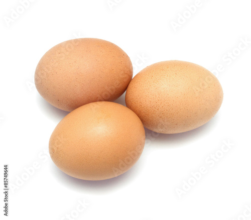 Three chicken eggs on white background