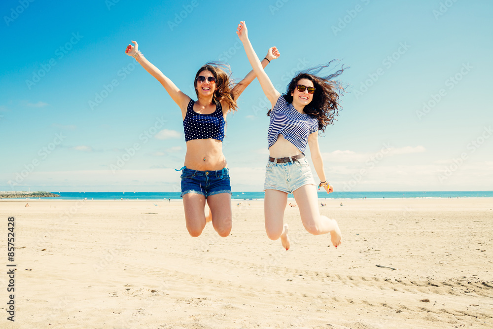 Funny girl frinds jumping on the beach Funny girl frinds jumping on the beach