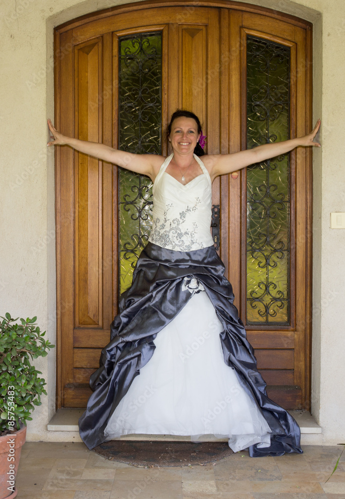 A brunette bride poses on her wedding day A brunette bride poses on her wedding day
