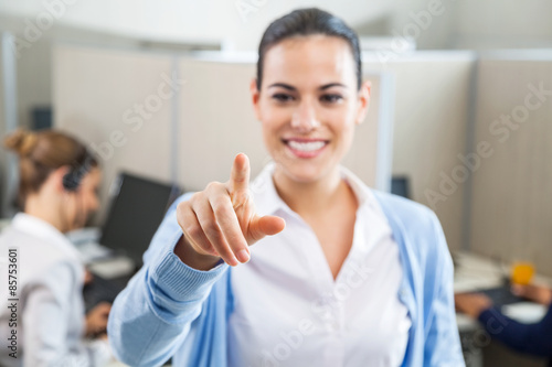 Smiling Female Customer Service Executive Pointing At You