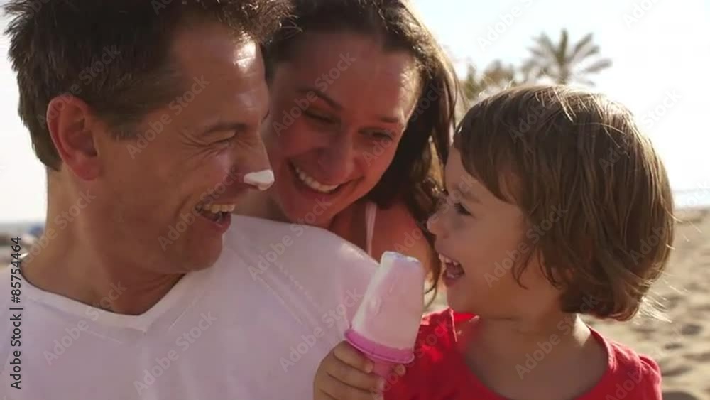Family eating popsicles at the beach. Family eating popsicles at the beach.