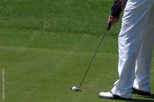 Golf ball behind driver at driving range