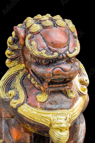 isolated Chinese style golden lion sculpture in black background
