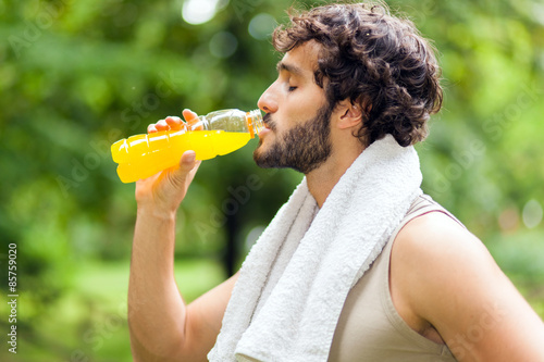 Fototapeta Naklejka Na Ścianę i Meble -  Young man drinking after sport