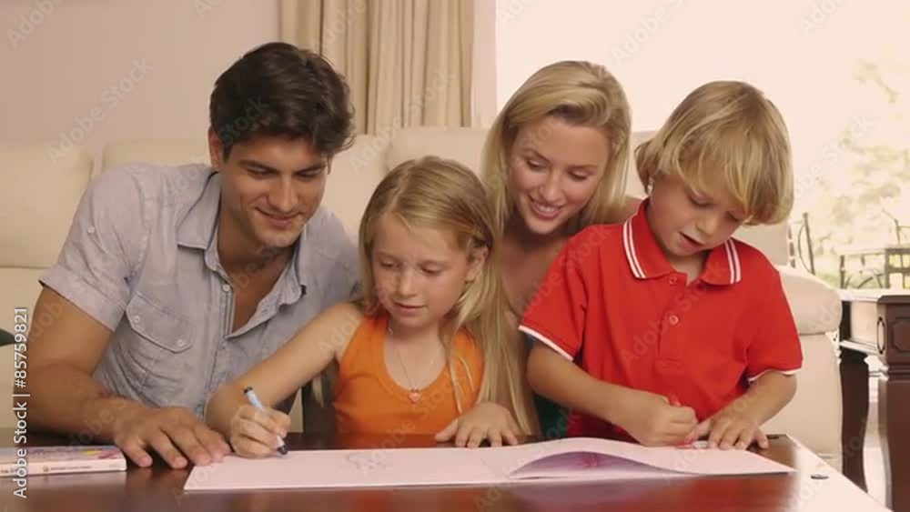 Family drawing and coloring together in living room. Family drawing and coloring together in living room.