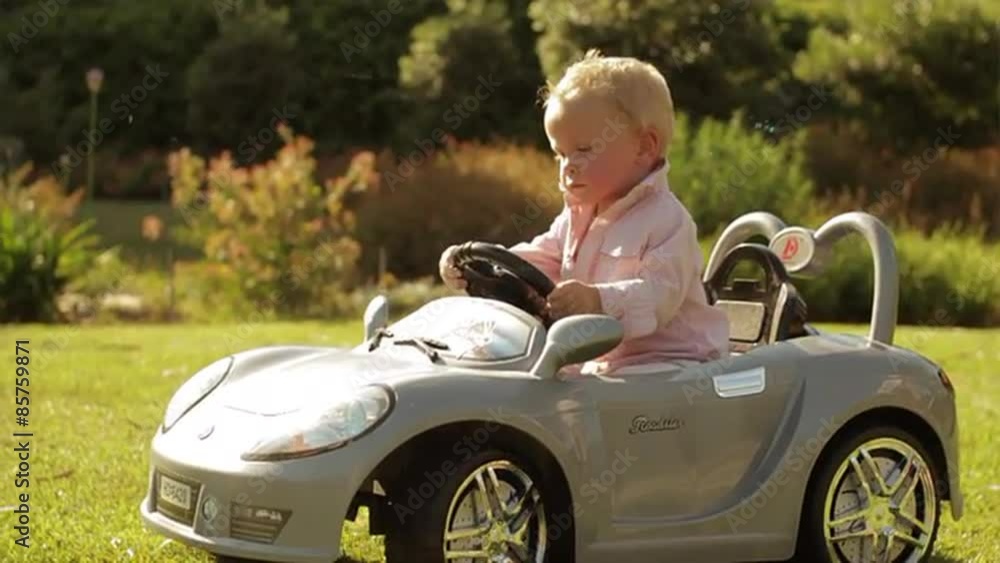 Slow motion of toddler playing in toy car. Slow motion of toddler playing in toy car.