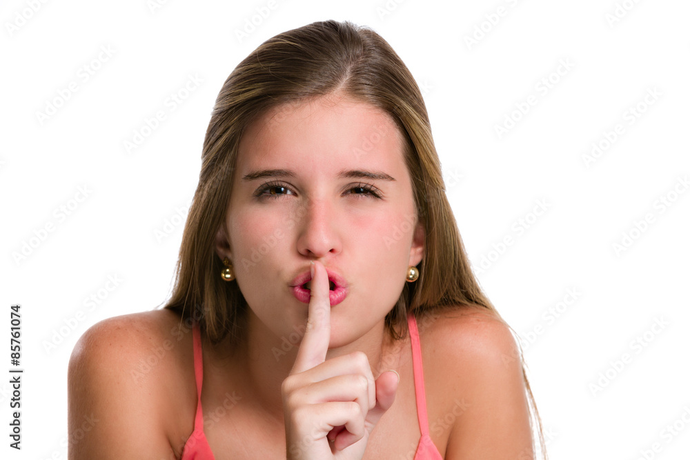 Cute Hispanic young woman with finger silence sign on mouth