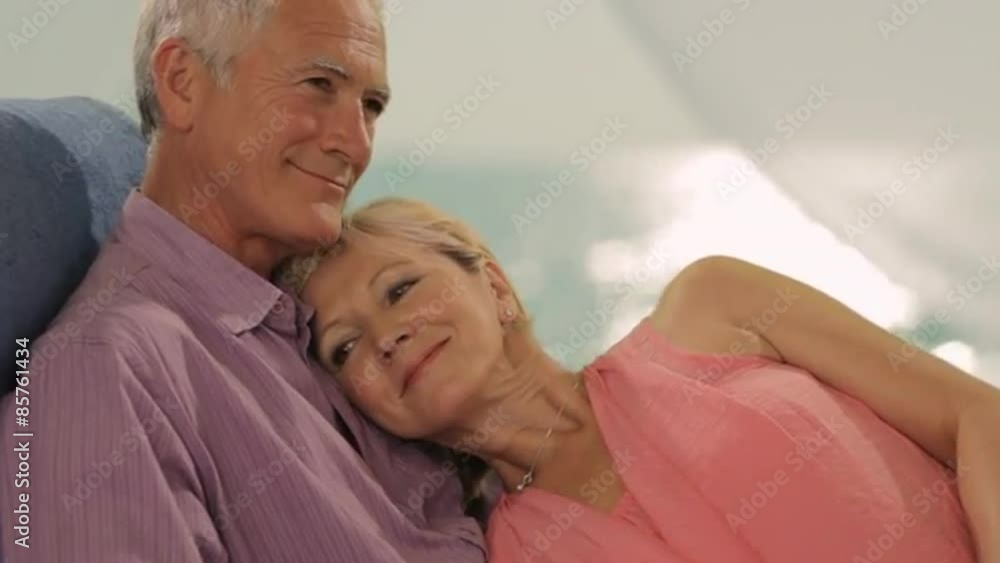 senior couple relaxing by beach and sea senior couple relaxing by beach and sea