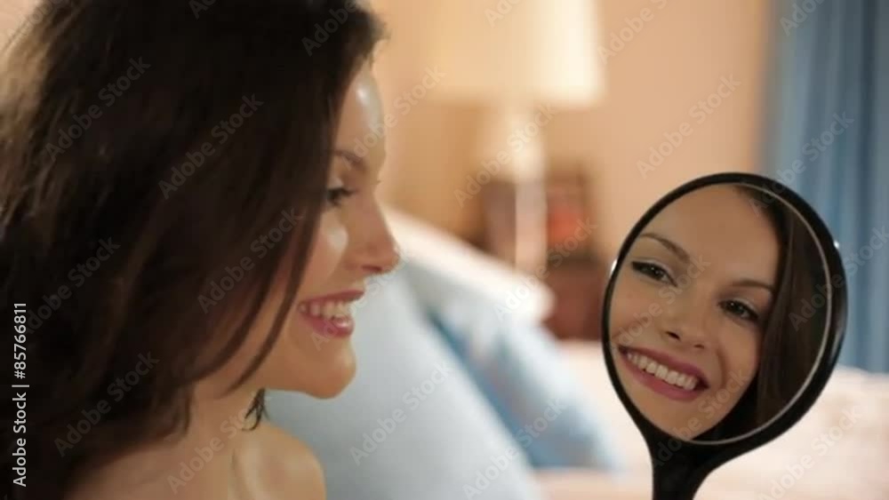 young girl in bedroom smiling into mirror young girl in bedroom smiling into mirror