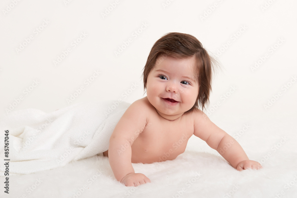 happy baby under towel on white happy baby under towel on white