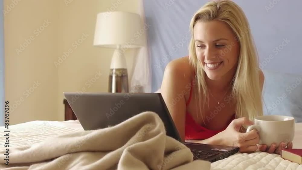 Woman drinking coffee in bed. Woman drinking coffee in bed.