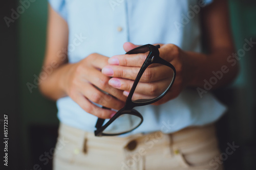 Human hands woman holding eyeglasses