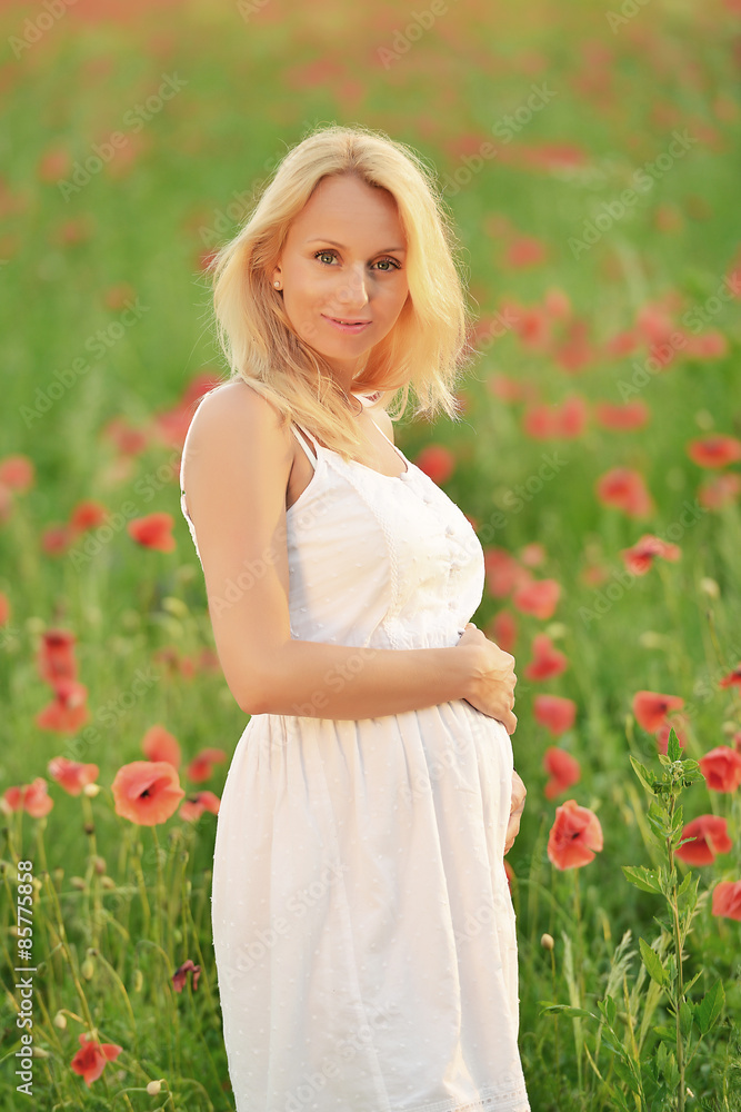 happy pregnant woman in poppie field happy pregnant woman in poppie field