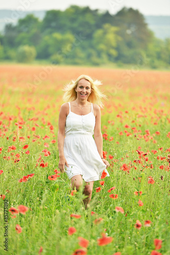 happy pregnant woman in poppie field