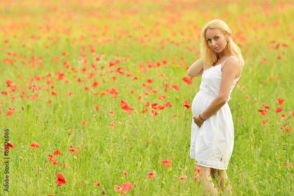 happy pregnant woman in poppie field happy pregnant woman in poppie field