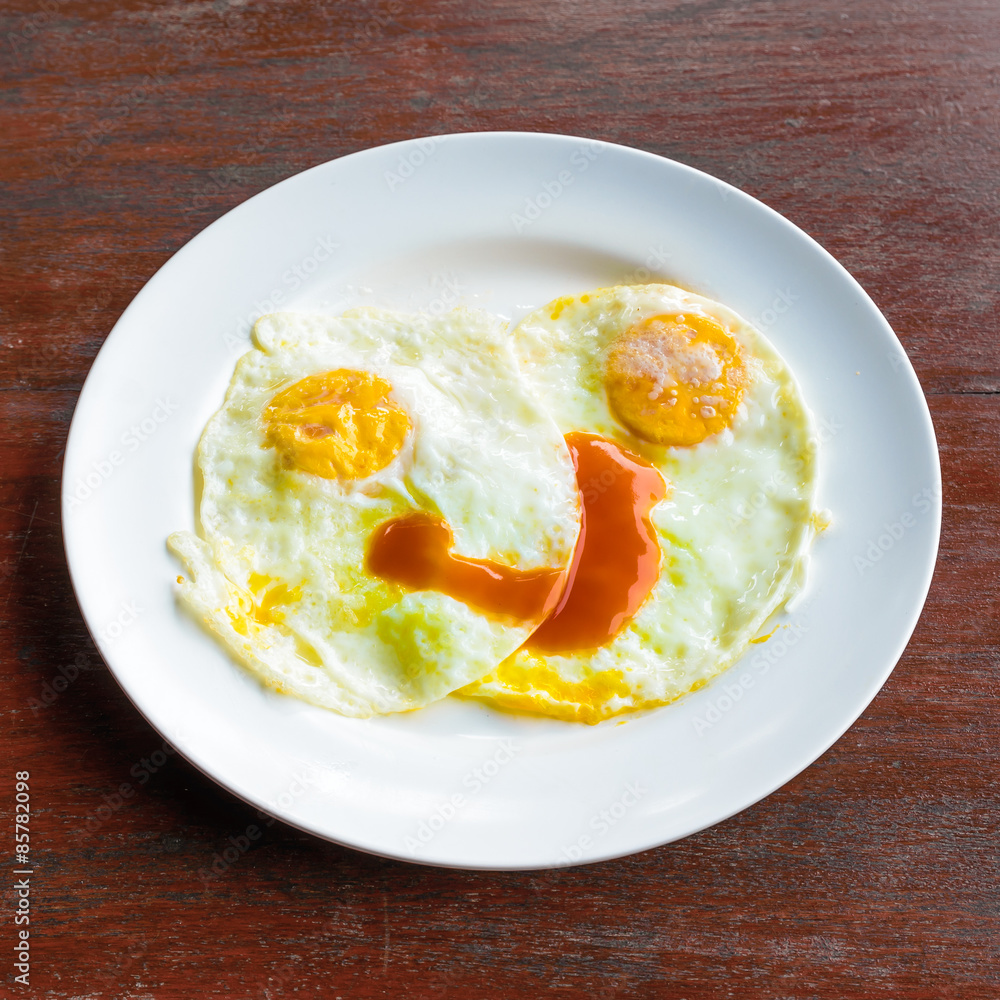 Looks delicious fried eggs on wooden table. Looks delicious fried eggs on wooden table.