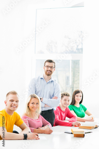 Group of teenage students studying at the lesson in the classroom