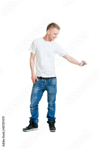 Teenage boy making a selfie isolated on white