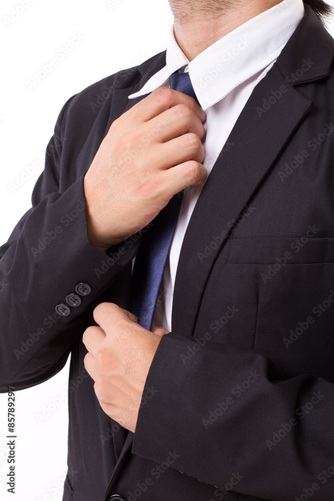 asian businessman fastening his necktie, ready to work