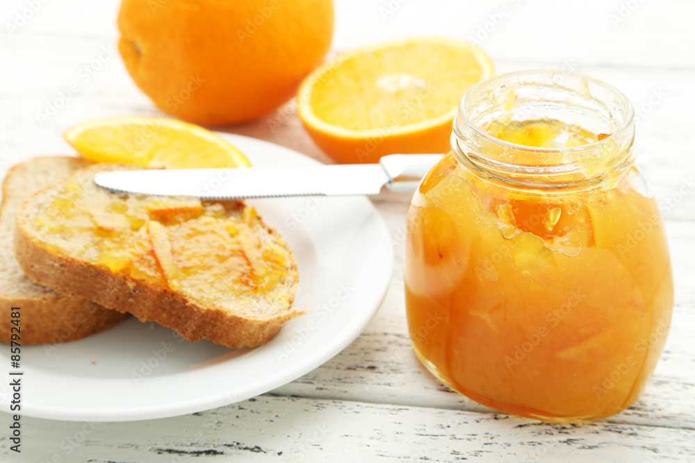 Bread with orange jam on white wooden background Bread with orange jam on white wooden background