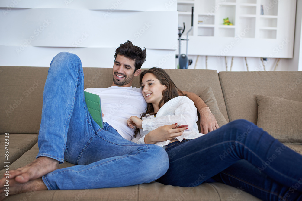 couple at modern home using tablet computer couple at modern home using tablet computer