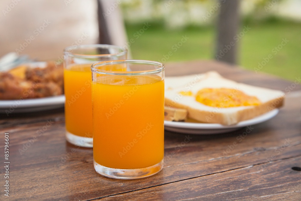 fresh orange juice with sliced bread background on wooden table fresh orange juice with sliced bread background on wooden table
